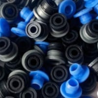 Pile of ECAS04 embedded Bowden collets with black push-fit bodies and blue release caps for 4 mm PTFE tube